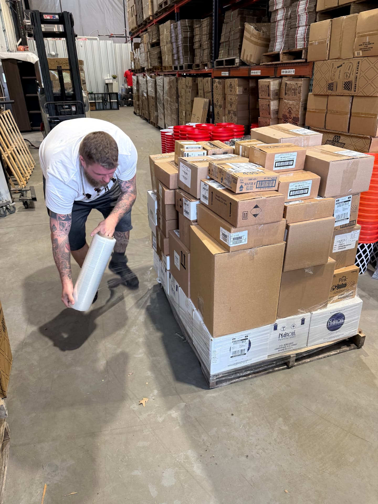 Every outbound pallet gets wrapped and labeled by hand before it ships.